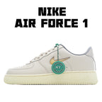 White low-top Nike Air Force 1 sneakers with green lace tag and side logo