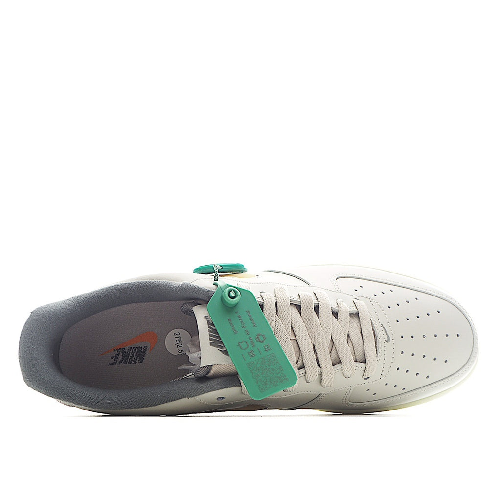 White Nike Air Force 1 sneakers with dark lining and green hang tag