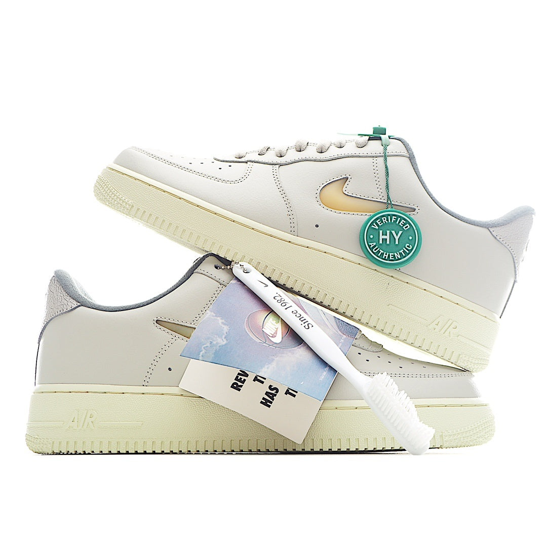 White Nike Air Force 1 sneakers with green lace loop and heel tag