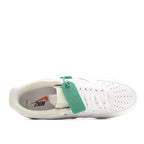 White low-top sneaker with white laces and green heel pull tab