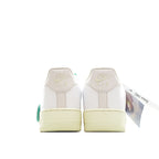 White low-top sneaker with Nike Air heel text and tan gum sole