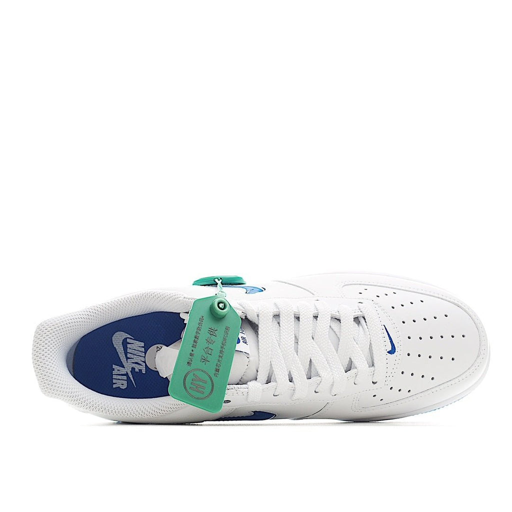 White Nike Air Force 1 sneaker with blue interior lining and teal pull tab