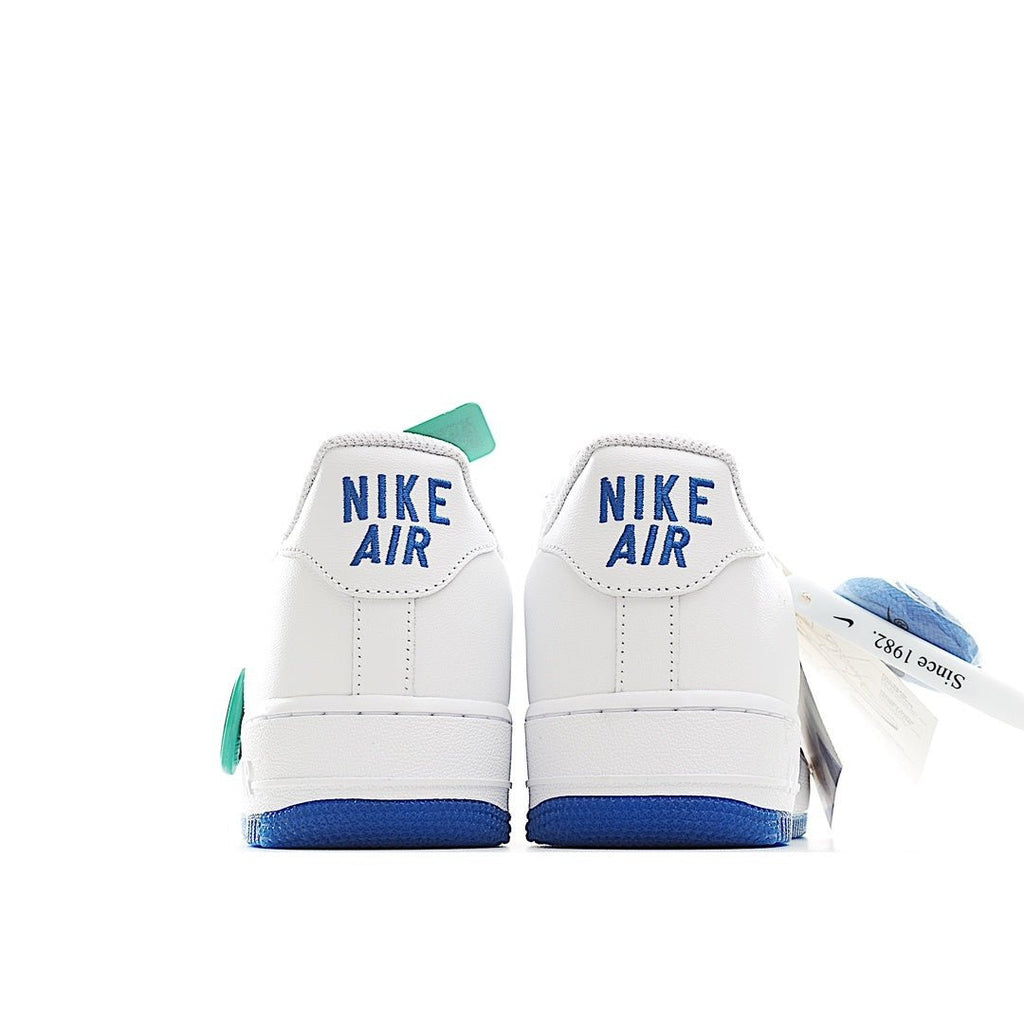 Back view of white Nike Air Force 1 sneakers with blue heel panels