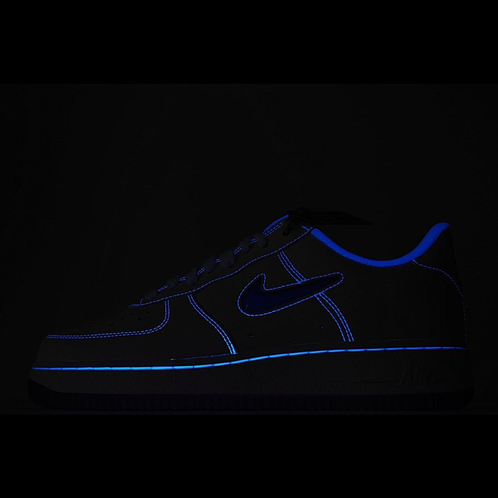 Dark Nike Air Force 1 sneaker with blue swoosh and contrast stitching