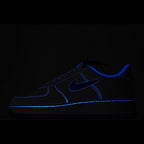 Dark Nike Air Force 1 sneaker with blue swoosh and contrast stitching