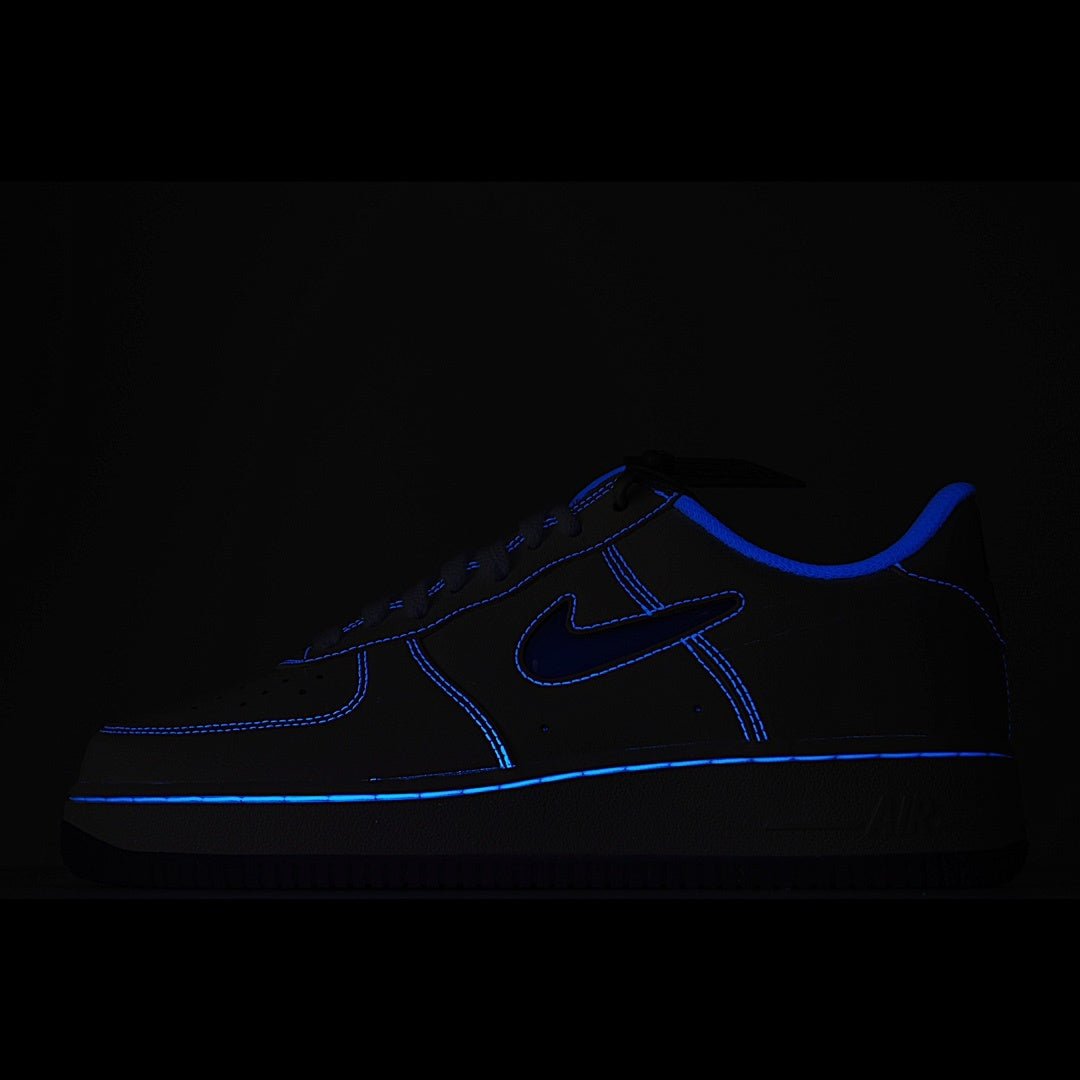 Dark Nike Air Force 1 sneaker with blue swoosh and contrast stitching