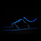 Dark sneaker with bright blue neon trim and blue laces on dark upper