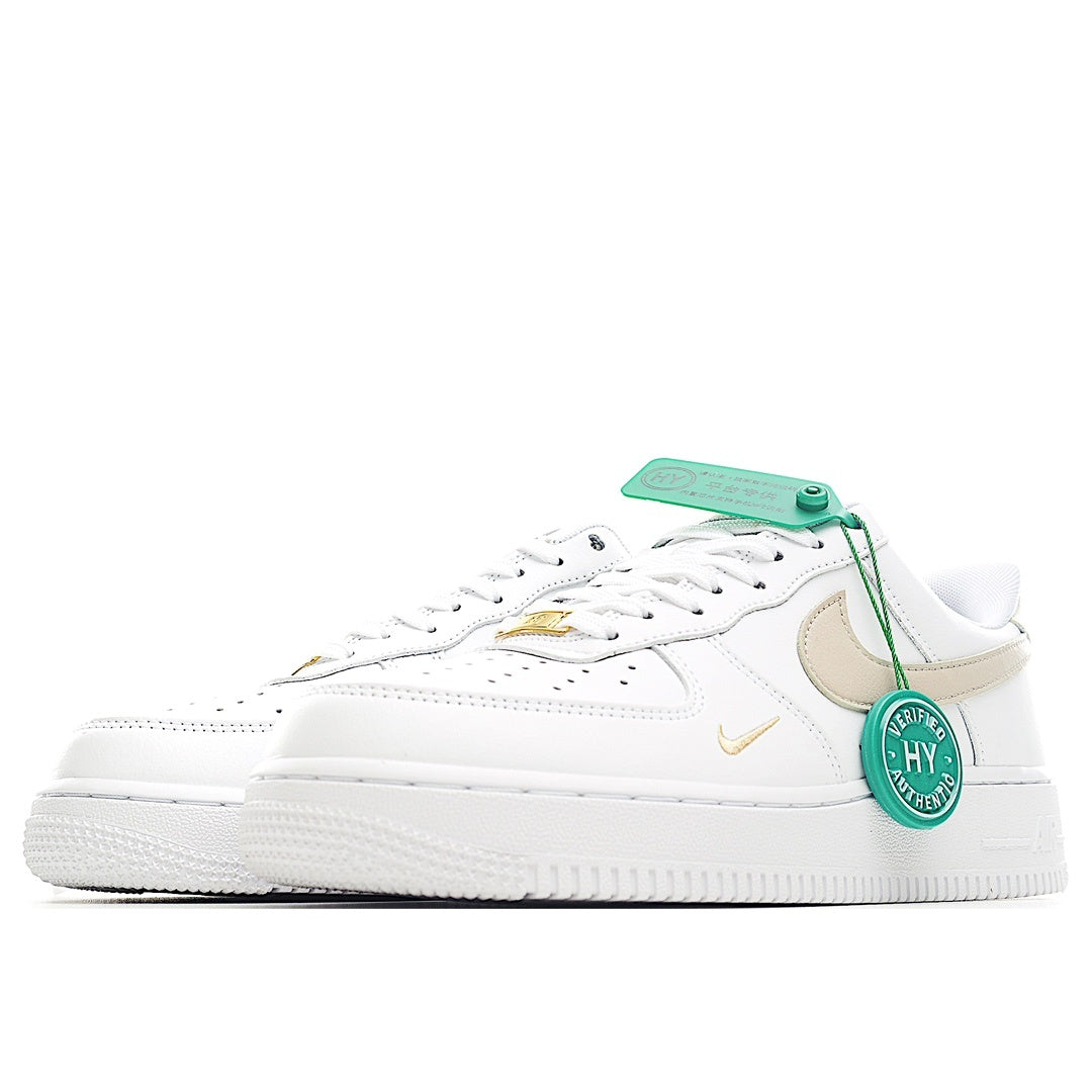 Nike Air Force 1 sneaker, white upper with beige swoosh and gold detail, green tag