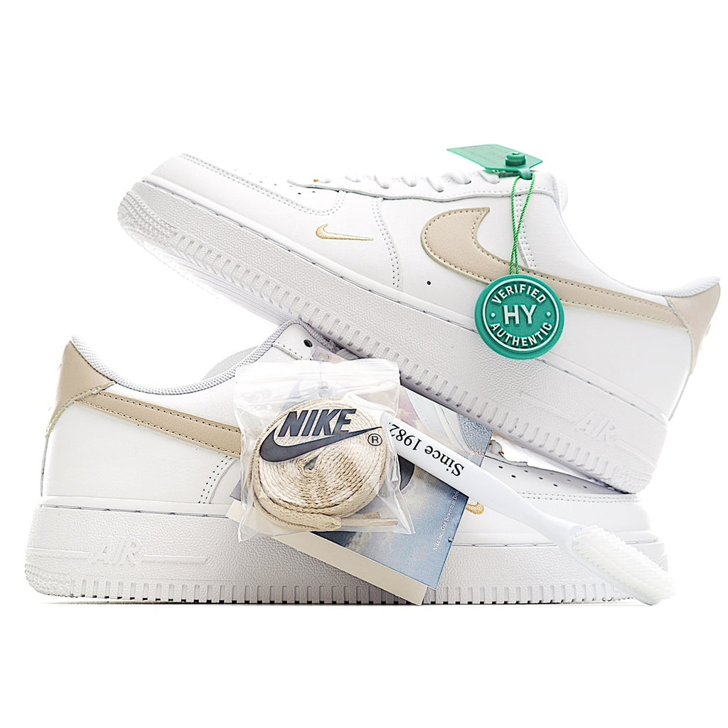 Nike Air Force 1 sneaker, white with beige swoosh and green authenticity tag