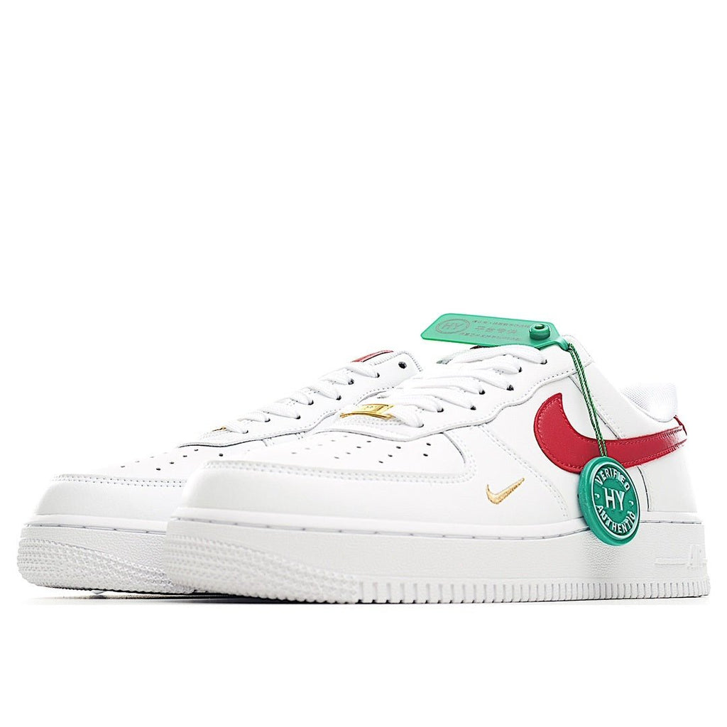 Nike Air Force 1 sneakers, white upper with red swoosh and green hang tag