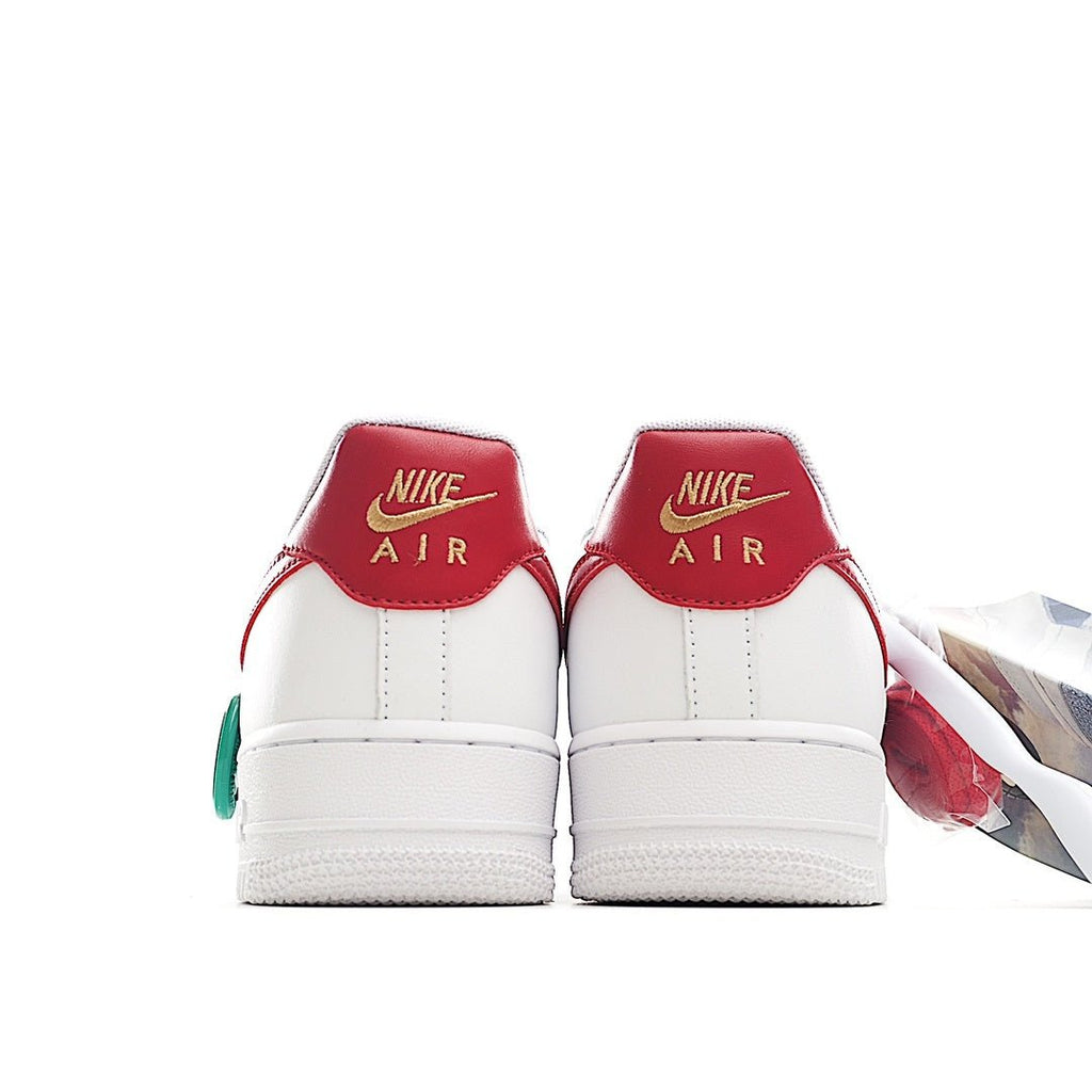Nike Air Force 1 sneakers, red heel panels with white toe and green lace loop
