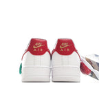 Nike Air Force 1 sneakers, red heel panels with white toe and green lace loop