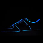 Low-top Nike sneakers with blue neon outline on dark upper