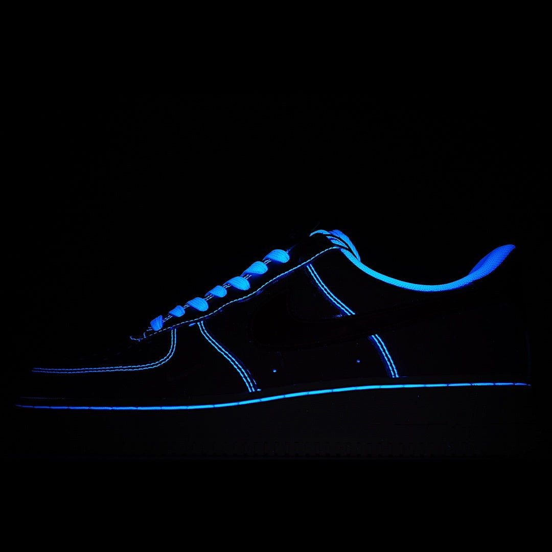 Low-top Nike sneakers with blue neon outline on dark upper