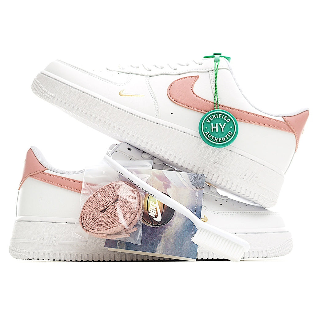 Nike Air Force 1 low-top sneakers, white uppers with pink overlays and green-tag lace