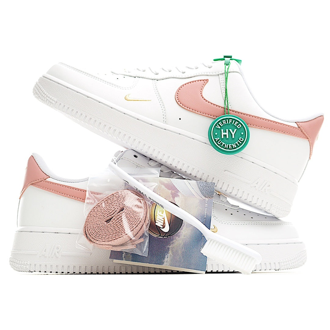 Nike Air Force 1 low-top sneakers, white uppers with pink overlays and green-tag lace