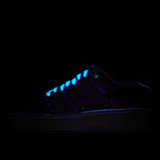 Dark sneaker with blue glowing accents and low-top silhouette.