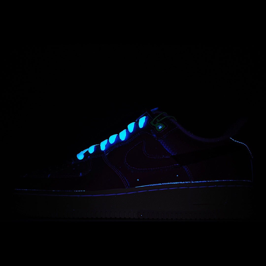 Dark sneaker with blue glowing accents and low-top silhouette.