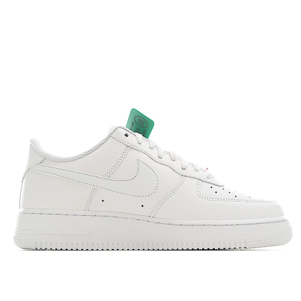 Nike Air Force 1 sneakers, white leather side profile with green hang tag