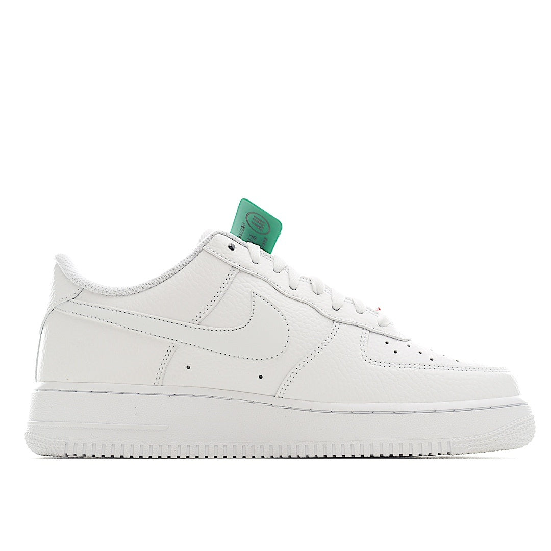 Nike Air Force 1 sneakers, white leather side profile with green hang tag