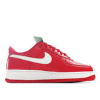 Red low-top sneakers with white swoosh and laces, green hang tag on tongue