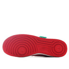 Red rubber sneaker outsole with circular tread pattern and Nike logo