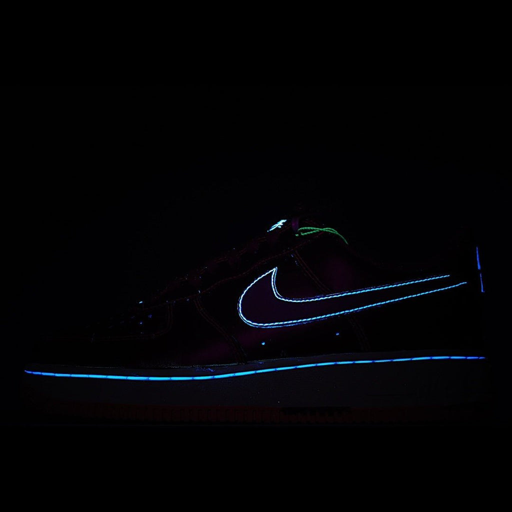 Dark sneakers with glowing blue Nike swoosh and outline on a black background