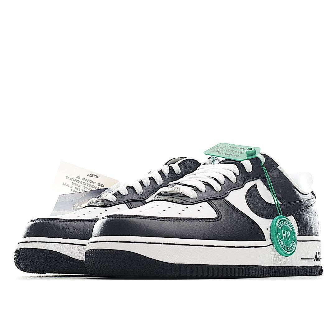 Black and white low-top sneakers with green trim, lace-up, side swoosh detail