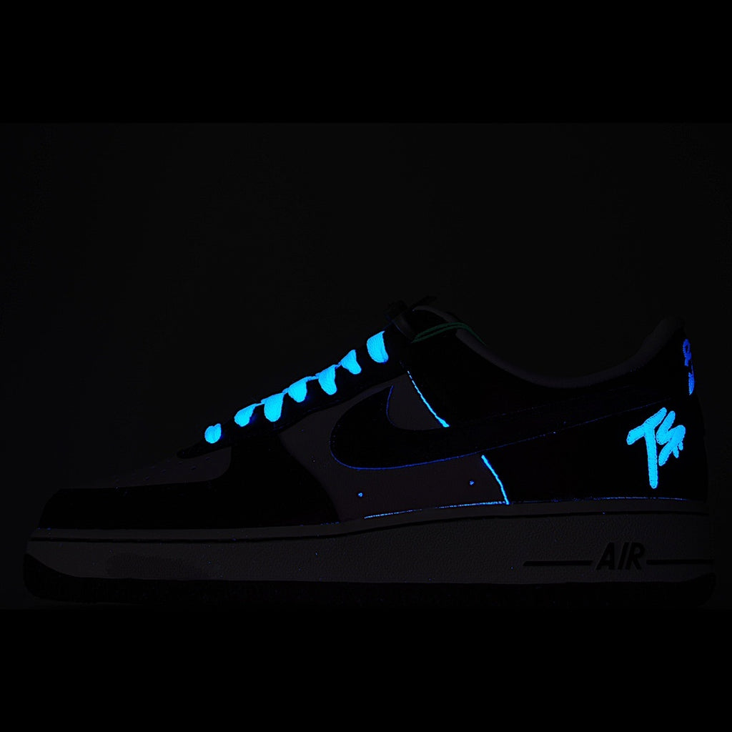 Dark Nike Air Force 1 sneakers with blue glowing lace and swoosh accents