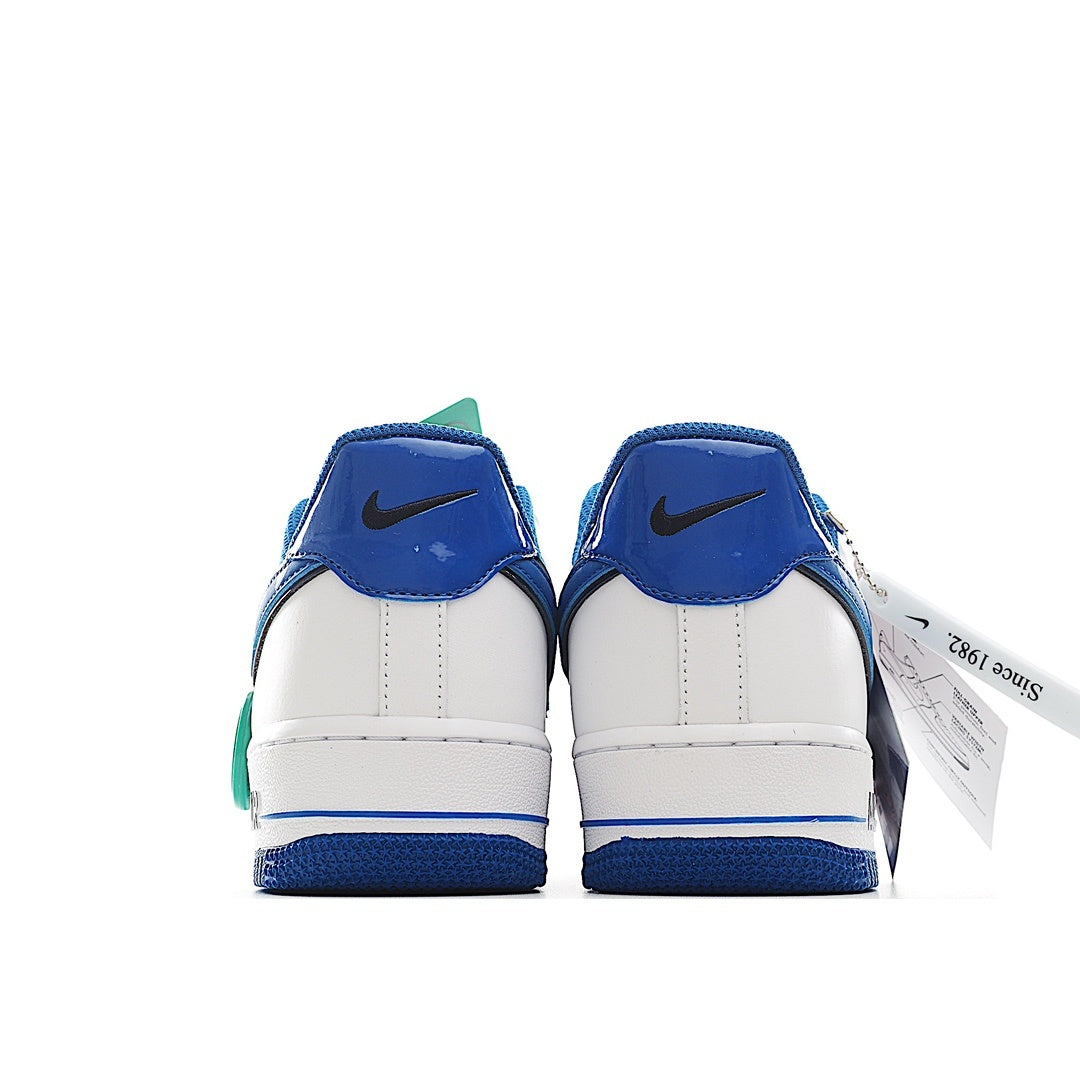 Nike Air Force 1 low-top sneakers, white sides with blue heel panels and green lace detail
