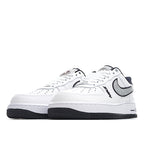 White low-top sneaker pair, front view with black Swoosh and navy heel tab.