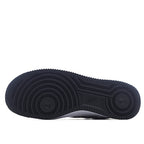 Black rubber outsole with circular traction pattern, full bottom view.