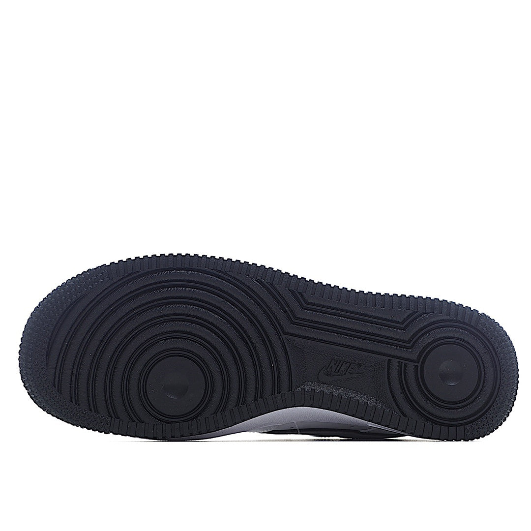 Black rubber outsole with circular traction pattern, full bottom view.