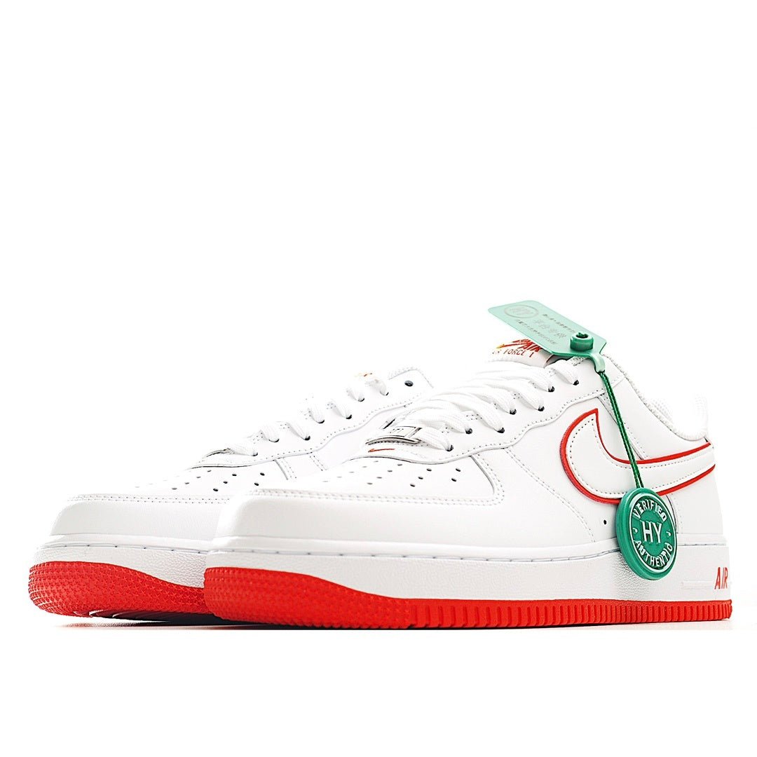 White Air Force 1 sneaker side view with red swoosh, green hanging tag, red outsole