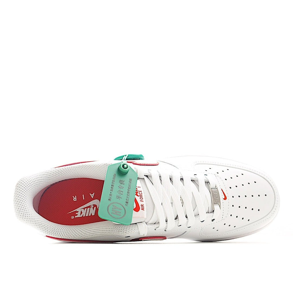 White Air Force 1 sneaker showing laces, perforations, and red-lined inner collar