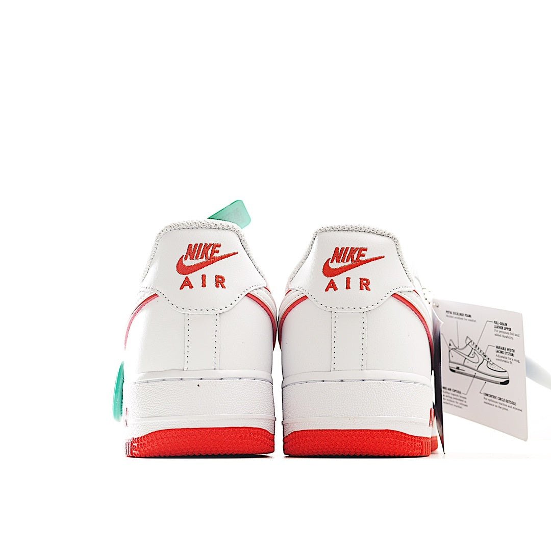 Pair of white Air Force 1 sneakers with red trim and teal “Air” heel details