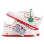 White Air Force 1 sneaker with green tag and red outsole, showing side profile