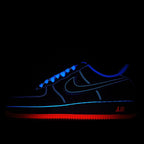 Dark blue Nike Air sneaker with blue neon trim and red “AIR” heel stripe
