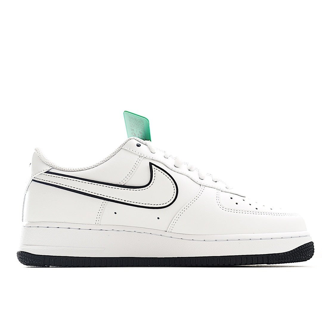 White low-top sneakers with black swoosh and green tongue tag