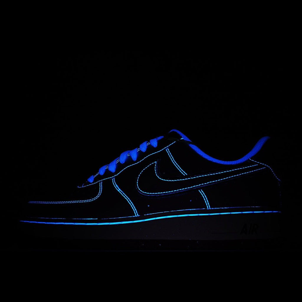 Dark blue low-top sneakers with black panels and neon blue trim; AIR sole mark