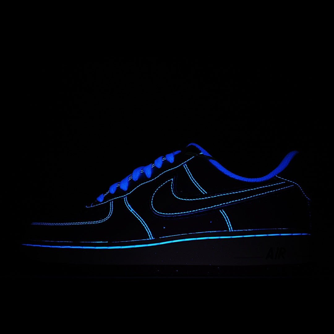 Dark blue low-top sneakers with black panels and neon blue trim; AIR sole mark