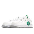 Nike Air Force 1 sneakers, white leather lace-up front view with green accents