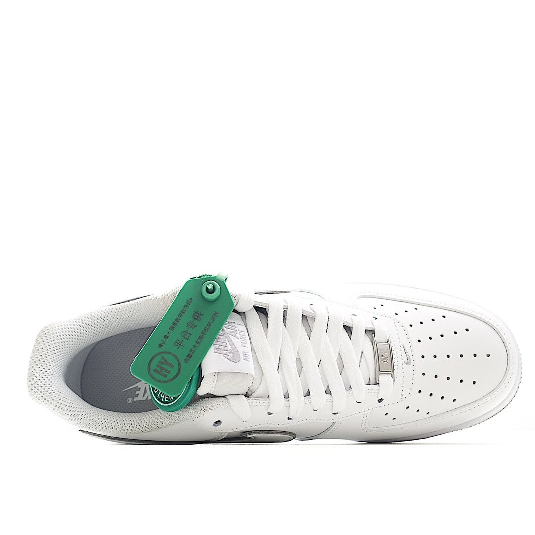 Nike Air Force 1 sneakers, white leather side view with laces and green hangtag