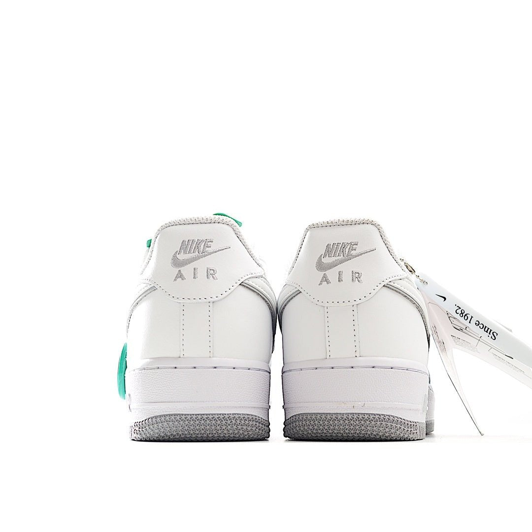 Nike Air Force 1 sneakers, white leather heel view with Air logo and green pull tab