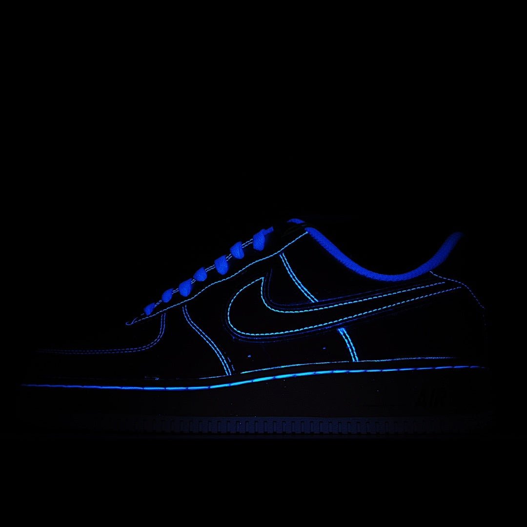 Nike Air Force 1 sneakers, dark blue upper with bright blue outline lighting