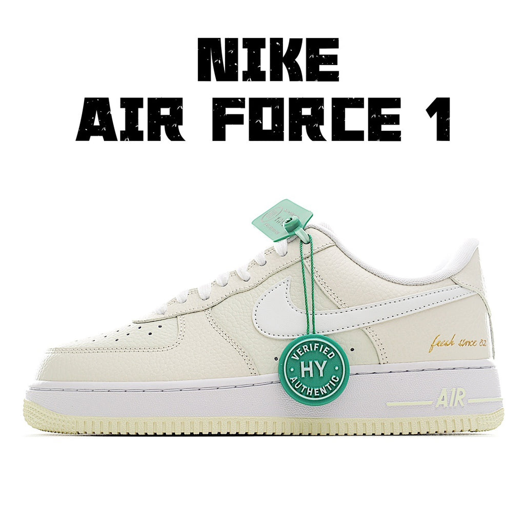 White Nike Air Force 1 sneakers with green tag and lace-up front