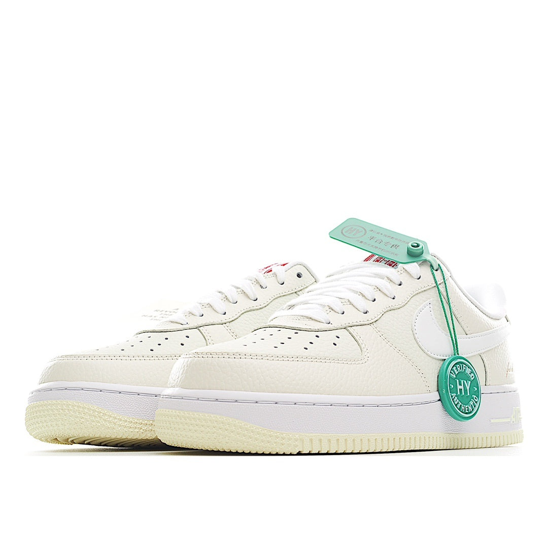 White Nike Air Force 1 sneakers, side view, green hang tag attached