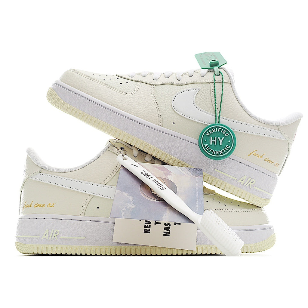 White Nike Air Force 1 sneakers with green hang tag and included insert cards