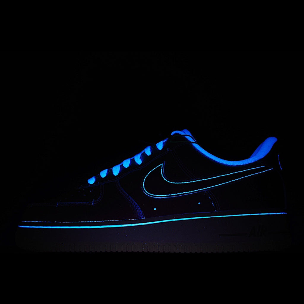 Dark blue sneakers with glowing blue swoosh and lace-up detail