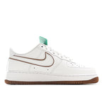Nike Air Force 1 low-top sneakers, white upper with tan swoosh stripe and brown outsole